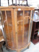 A china cabinet with glass shelves.