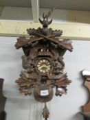 A cuckoo clock with three weights.