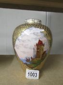 A 19th century gilded vase with hand painted panels.
