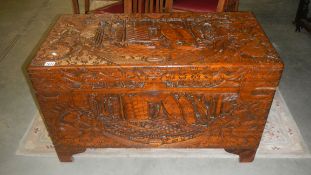 A large carved camphor wood chest.