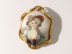 A Victorian painted porcelain brooch in yellow metal depicting Georgian/Gainsborough lady.