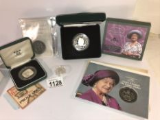 A Queen Mother 100 years Piedfort £5 coin, a 90th £5 coin and others.