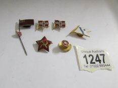 A collection of Soviet badges and pins, some with flag designs in enamel, (7 items in total).