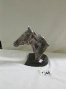 A silver hall marked horse head on stand by Donald Brindley.