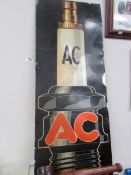 A modern 'AC' spark plug sign.