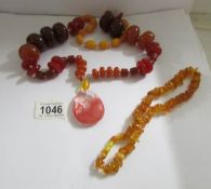 A natural amber necklace and a further larger necklace.