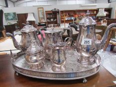 A silver plate tea set on tray.