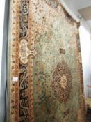 A green patterned Keshan rug, 230 x 160 cm.