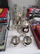 A 4 piece silver plated coffee set and a pair of silver plated candlesticks.