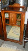 An inlaid cabinet with mirrored door.