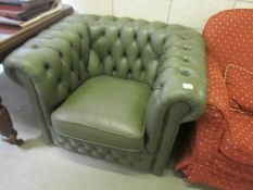 A green leather 'Chesterfield' chair.