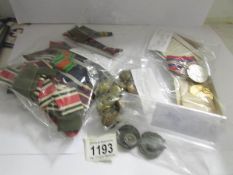 A quantity of military badges, buttons, medal etc.