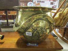 A large 19th century brass jardiniere with embossed dragon.