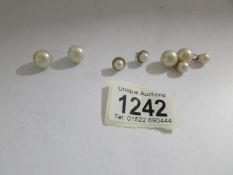 A pair of cultured pearl ear studs set in yellow metal and 2 pairs of pearl ear studs in various