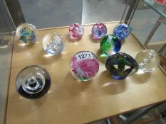 10 assorted glass paperweights.