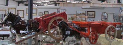 2 shire horses pulling hand built carts.