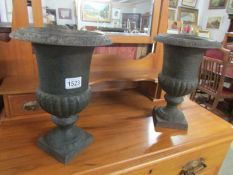 A pair of Victorian cast iron garden urns.
