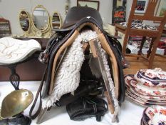 A leather saddle with stand and Numna with stirrups,