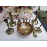 A pair of 19th century brass candlesticks, a brass 'prayer' bowl, nutcrackers, brass bell,