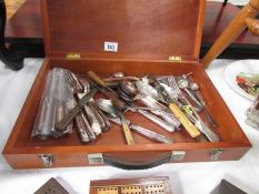 A mixed lot of cutlery in wooden case,.