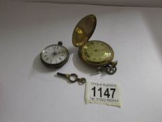 A ladies white metal fob watch a/f and a brass full hunter pocket watch with key also a/f.