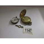A ladies white metal fob watch a/f and a brass full hunter pocket watch with key also a/f.