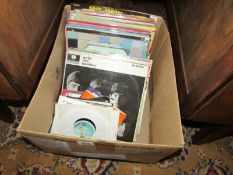 A box of LP and 45 rpm records including Beatles.