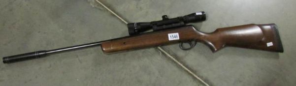 An air rifle with sight and silencer.