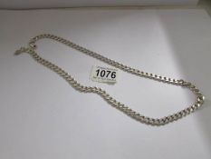 A silver kerb link chain, approximately 25" long, 62.2 grams.