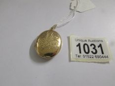 A 9ct gold engraved front locket, approximately 9.75 grams.