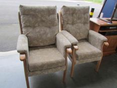 A pair of good quality wood framed arm chairs.