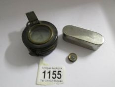 An old brass compass and a smaller example.