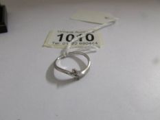 A 2 stone white gold crossover ring, size N.