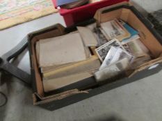 A box of old art books and ephemera including prints, posters and real photographic postcards,