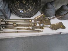 A quantity of brass fire irons.