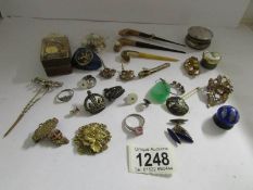 A mixed lot of jewellery including various military badges with crown motifs, an enamelled box,