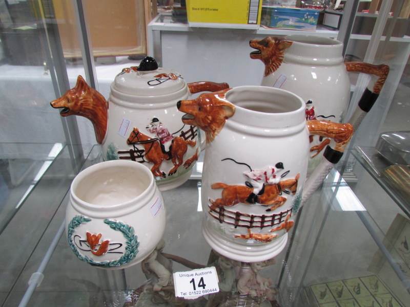 A teapot, 2 jugs and a sugar bowl all with hunting scenes.