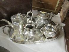 A silver plated tray, 2 teapots, milk jug and sugar bowl.