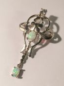 A gem set opal brooch/pendant in silver coloured metal.