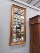 A gilt framed bevel edged mirror.