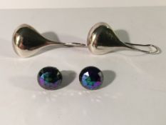 A pair of pendant drop earring in silver and a further pair in an irridescant stone setting