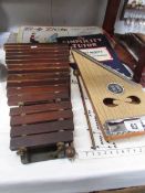 A 'Zippy Zither' (box distressed) and a Boosey & Hawkes xylophone with hammers.