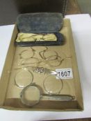 A quantity of vintage spectacles, magnifying glass etc.