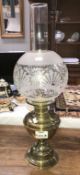 A brass oil lamp with globe & chimney