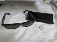 A cased pair of Ray-Ban sunglasses.