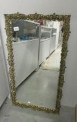 A brass ormolu style framed mirror.