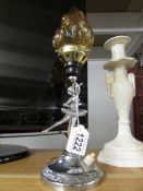 A chrome art deco figure lamp with amber glass flame shade.