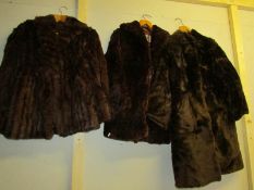 A fur coat and 2 fur jackets.