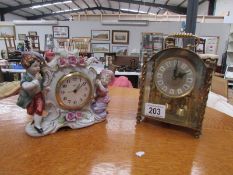 An Anniversary clock (feather damaged) and a ceramic figural clock.