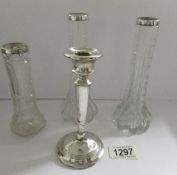 A pair of silver rimmed vases, one other and an a/f silver candlestick.